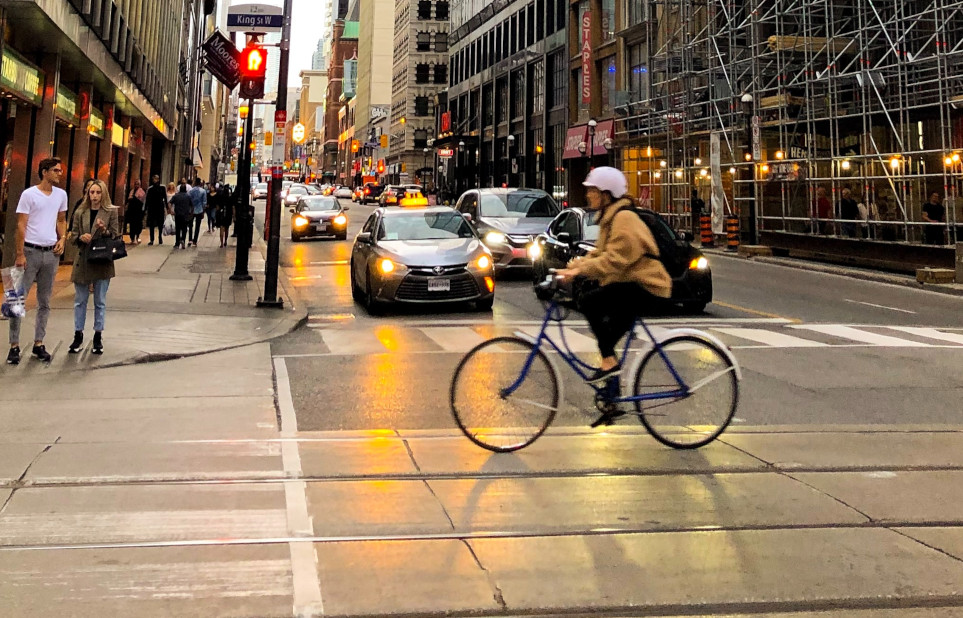 cyclist riding in cold urban downtown