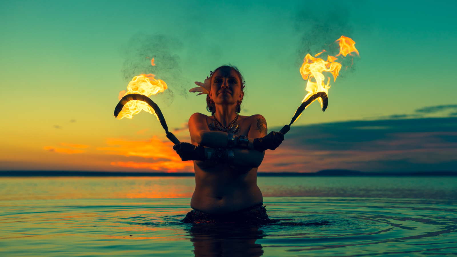 Woman in lake with flaming branches