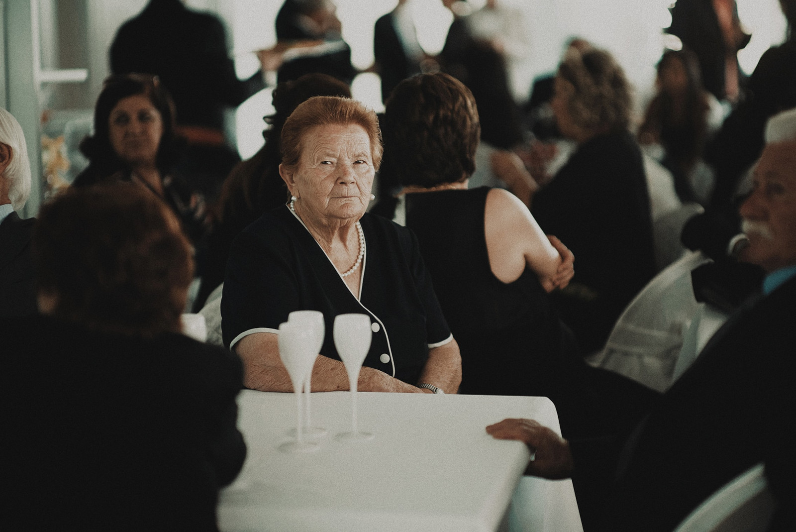 Older woman, seated, in black dress