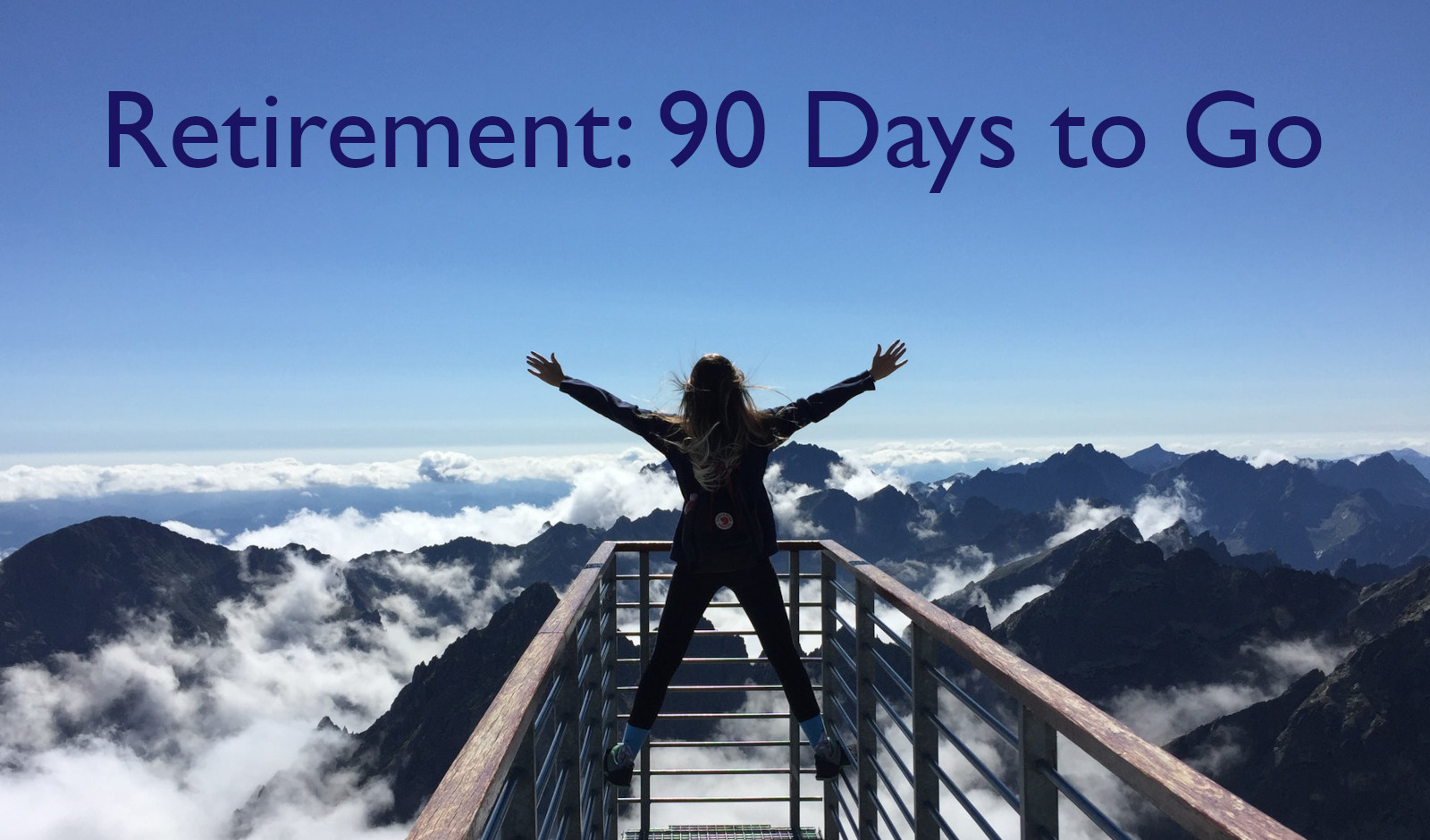 Woman standing on handrails overlooking mountains and fog