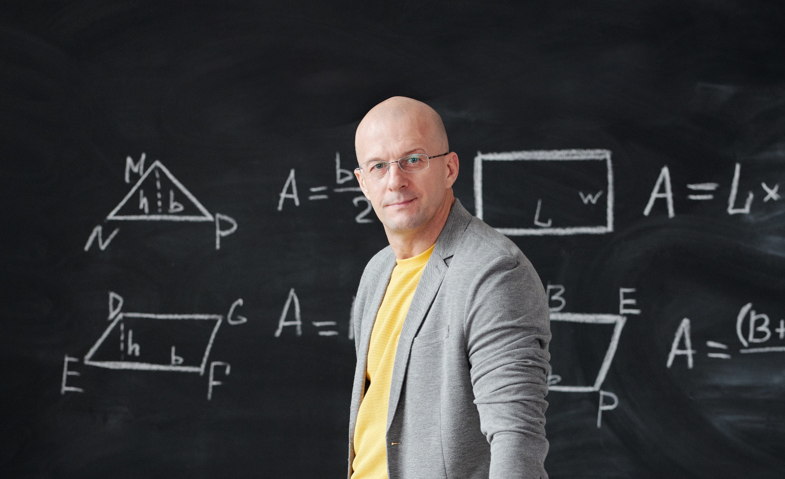 Man in front of blackboard with equations