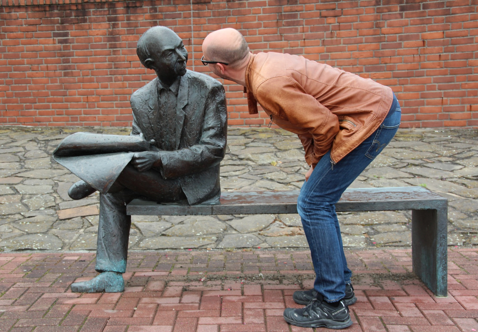 Man looking eye to eye at statue