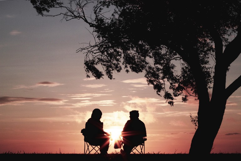 Couple resting at sunset