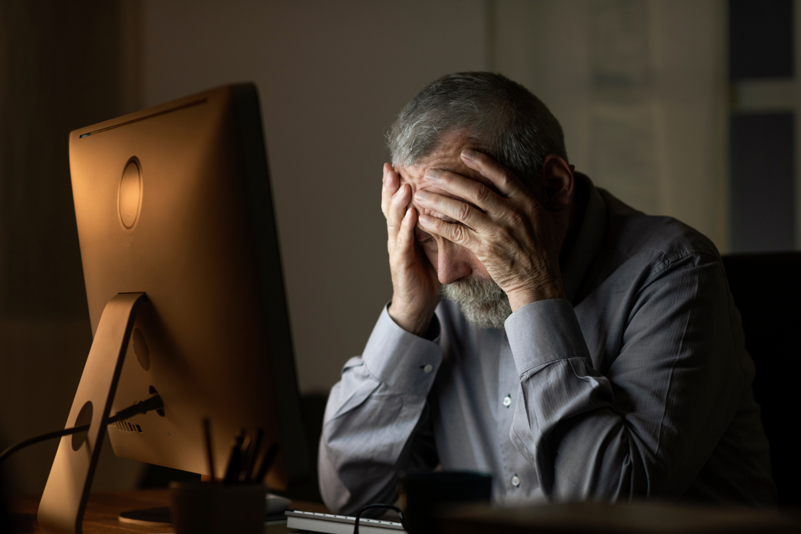 Older man deeply frustrated by his computer