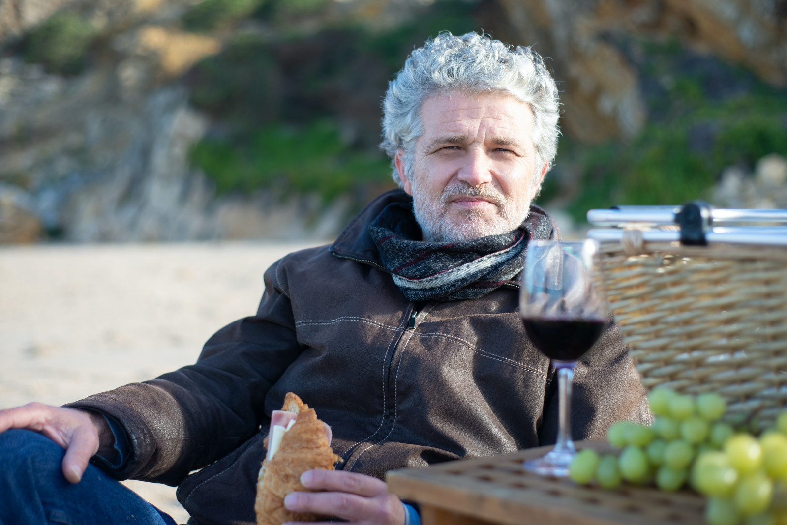 relaxed man with wine and a sandwich