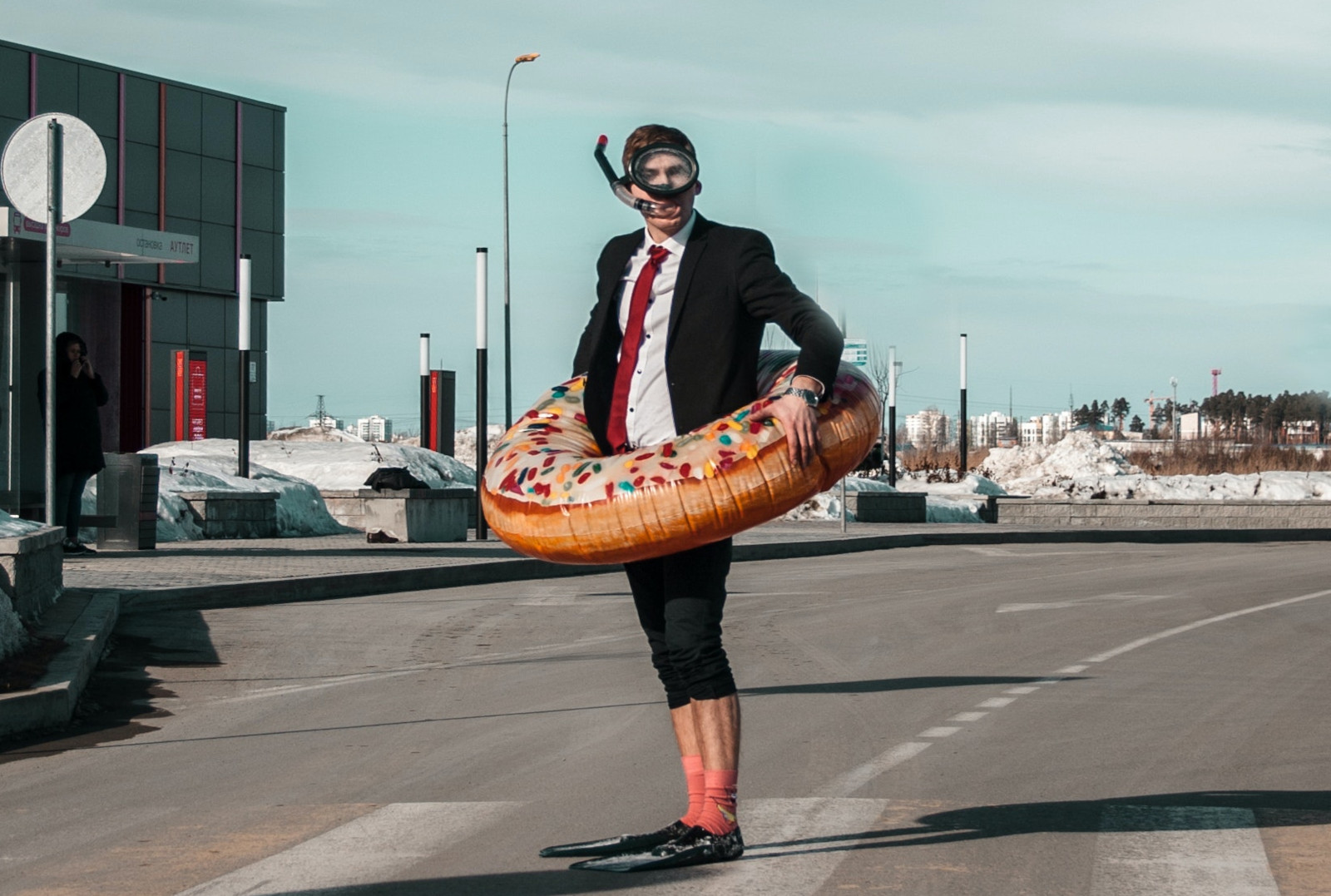 Crazy man wearing a plastic donut and snorkel gear while wearing a suit