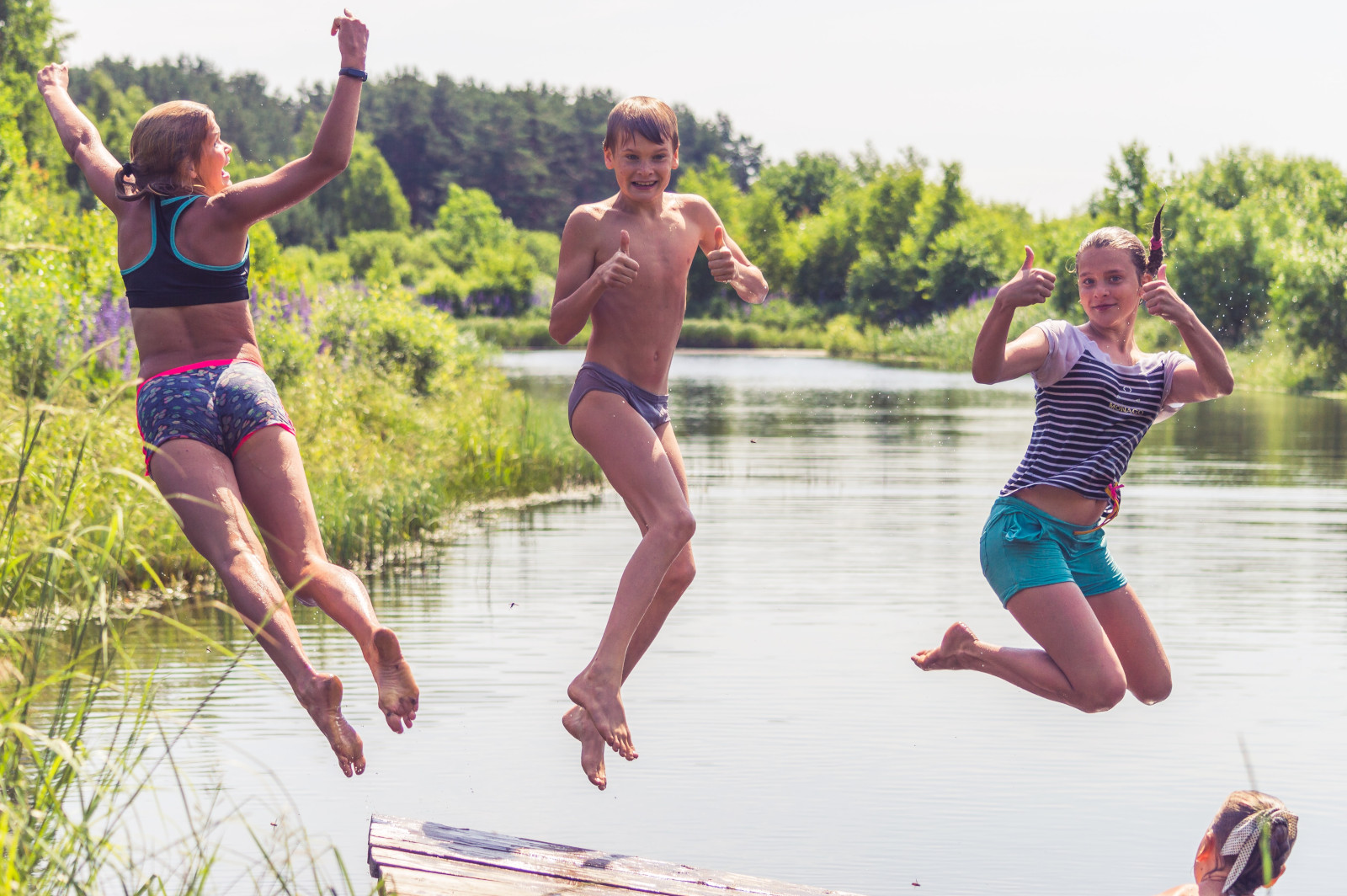 Kids jumping into river