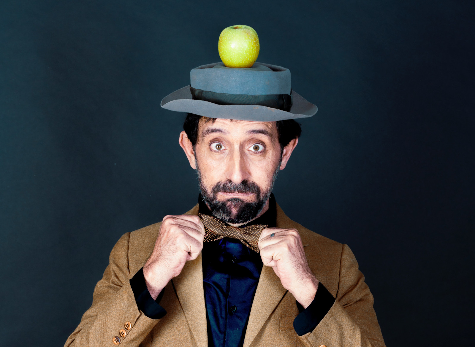 Funny looking man with apple on his head